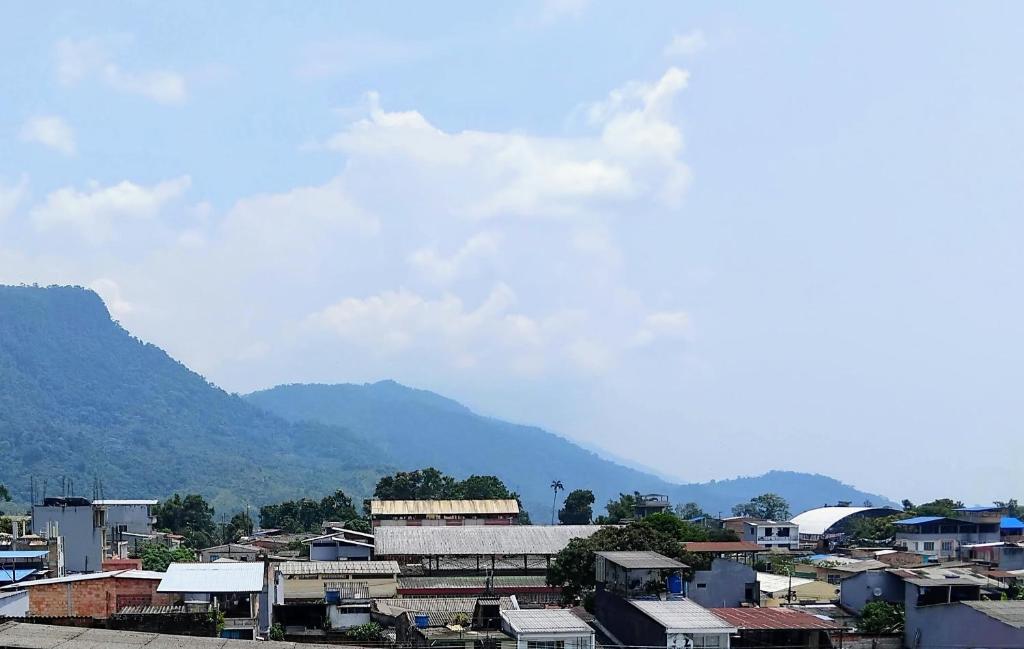 a city with houses and mountains in the background at Hotel Real, Villa Garzón in Villagarzón