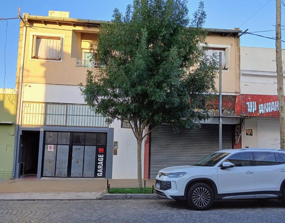 a white car parked in front of a building at Apart Don Ángel Tandil in Tandil