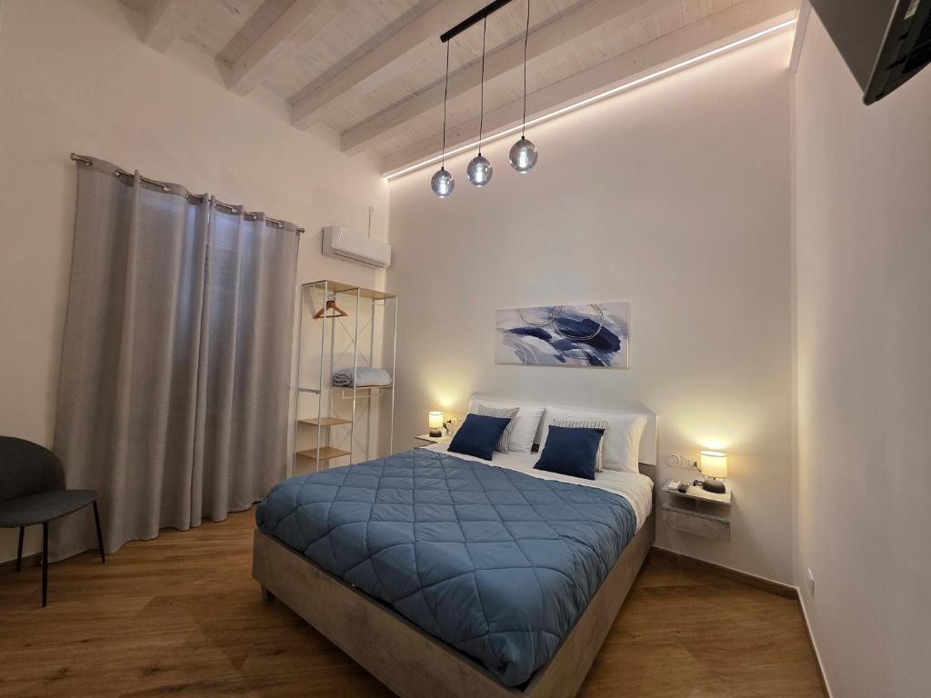 a bedroom with a bed with a blue blanket at Marèa in Porticello