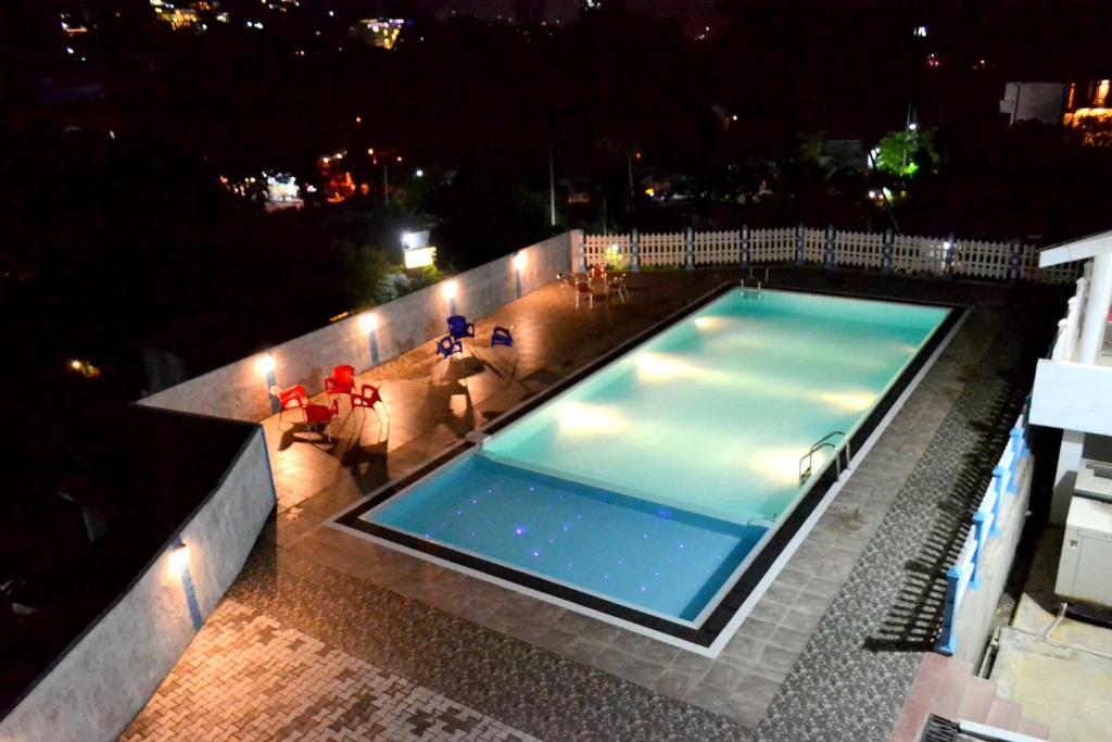 an overhead view of a swimming pool at night at Capital Regency in Kandy