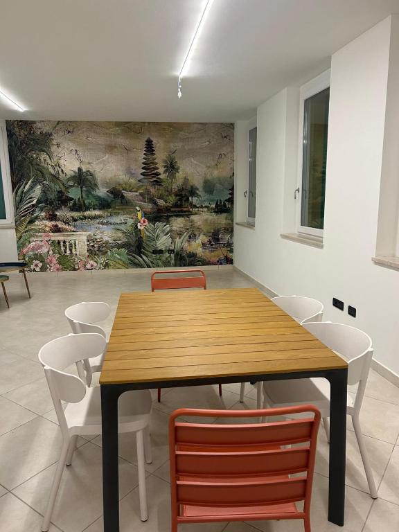 a dining room with a wooden table and chairs at Nuvole e Miracoli - foresteria in Bagnolo Mella