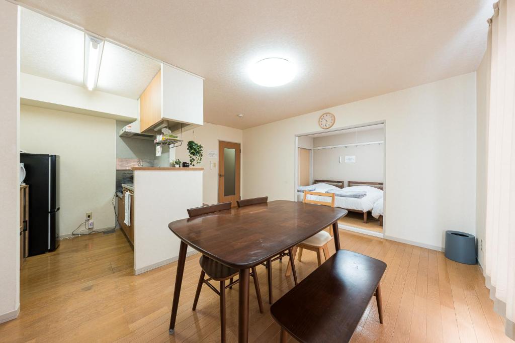 a kitchen and dining room with a table and chairs at アルカディアｋ in Aomori