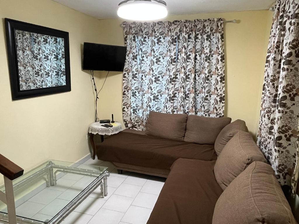 a living room with a couch and a window at Casa Canaan in Monterrey