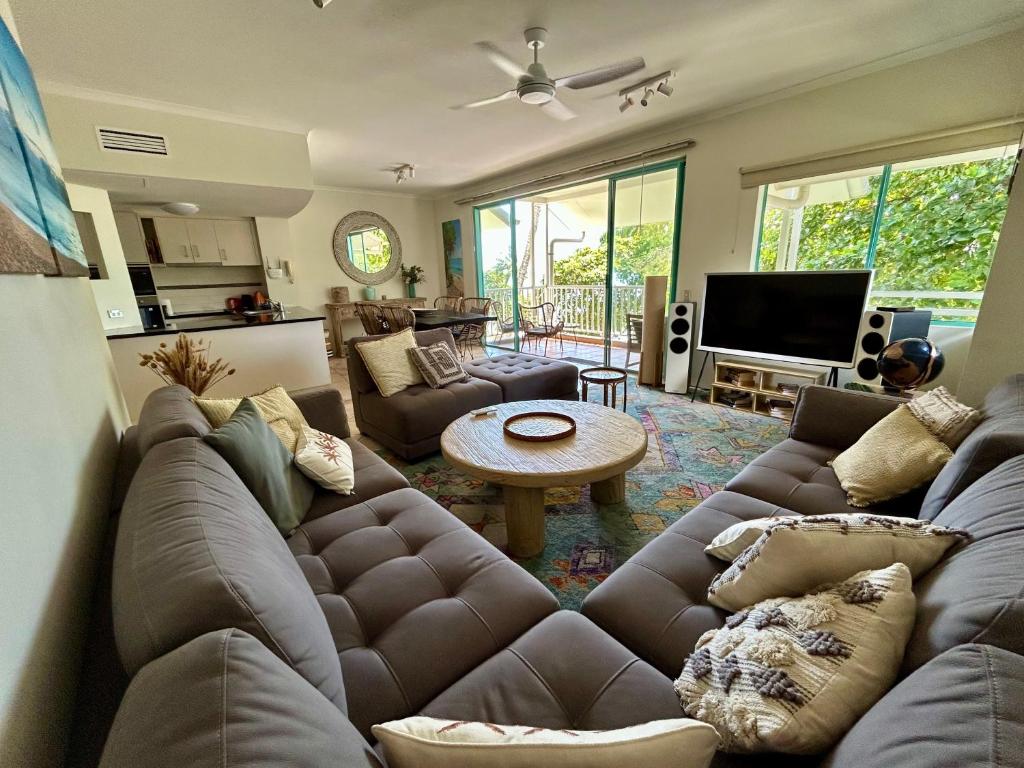 a living room with a couch and a table at The Beachfront in Trinity Beach