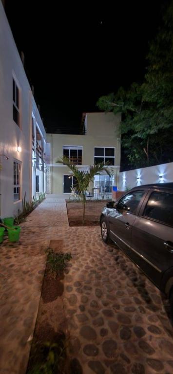 a car parked in front of a building at night at Meztli Beach House in La Manzanilla