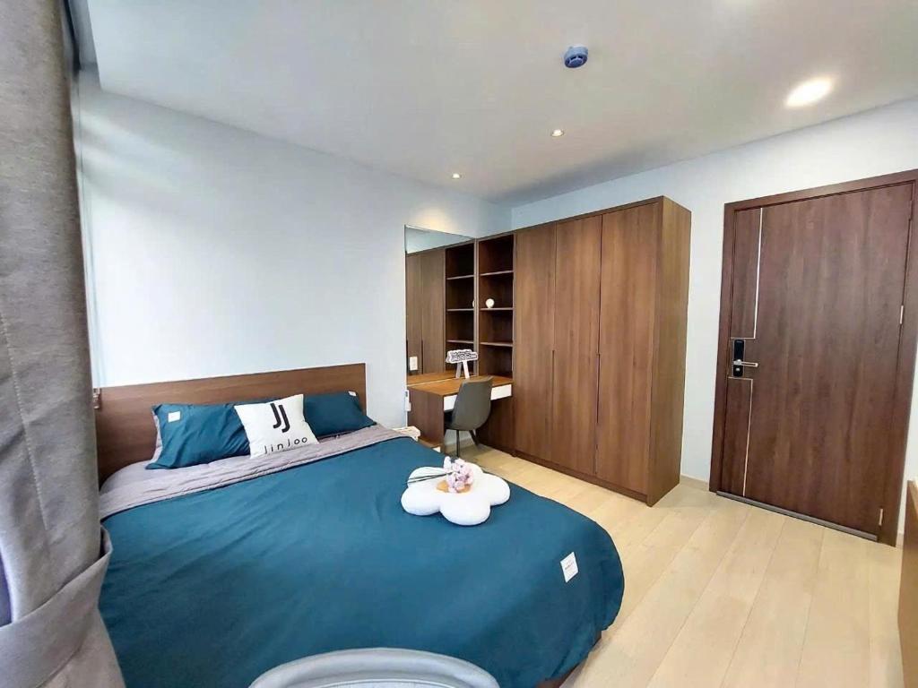 a bedroom with a large blue bed and a desk at Lunaria Maison - HCM Center Stay in Ho Chi Minh City