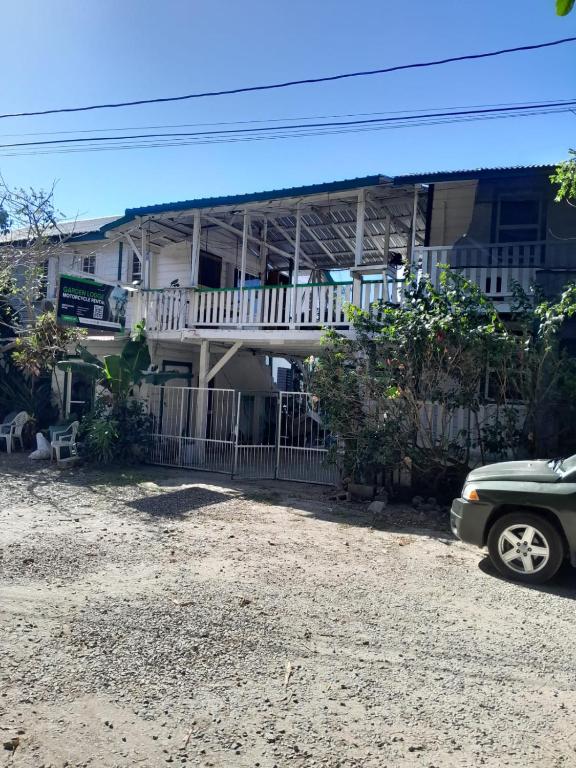 a car parked in front of a house at Garden Lodge Hotel in Placencia