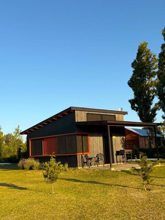 a modern house with a garden in front of it at Almada - Casas de Campo in Baradero
