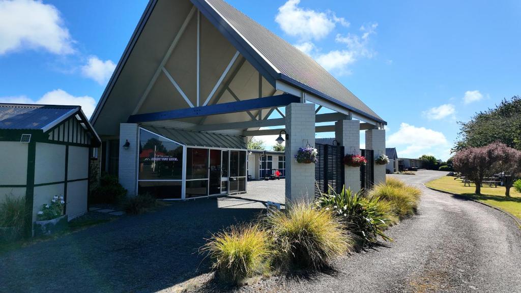 a building with plants in front of it at Mount View Motel Hawera in Hawera
