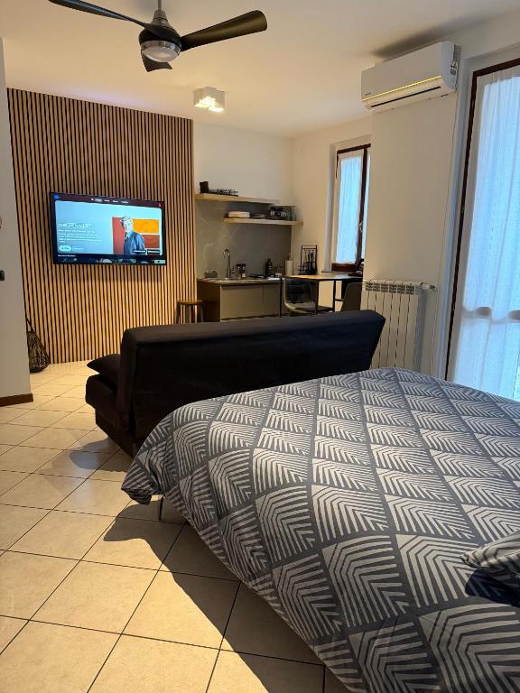 a bedroom with a bed and a flat screen tv at Jasmine garden apartment in Capriate San Gervasio