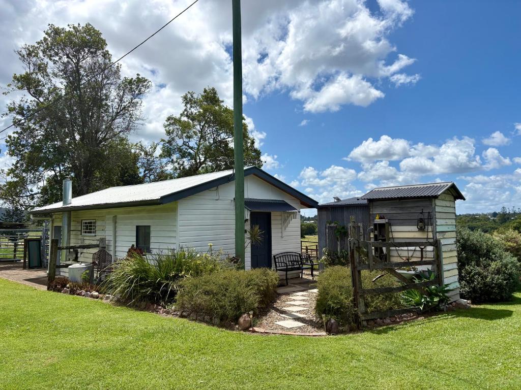 a small house with a pole in a yard at Edington on Mary - The Dairy in Gympie