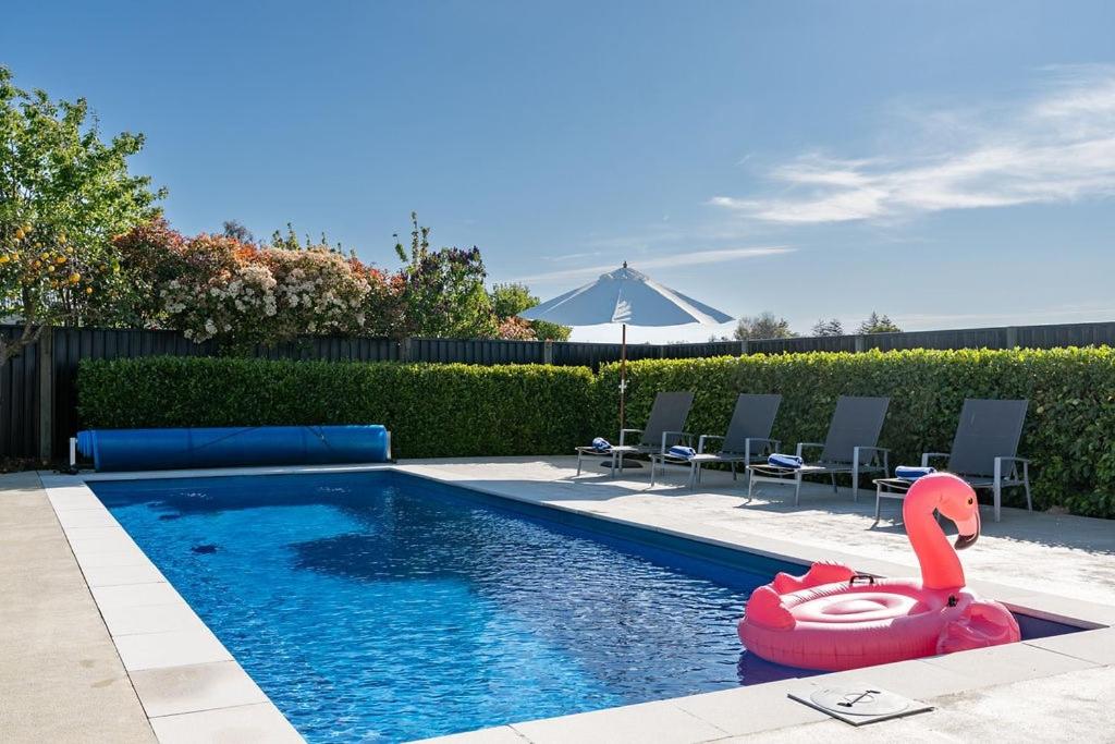 a swimming pool with a swan in the middle at Sunset Villa in Martinborough