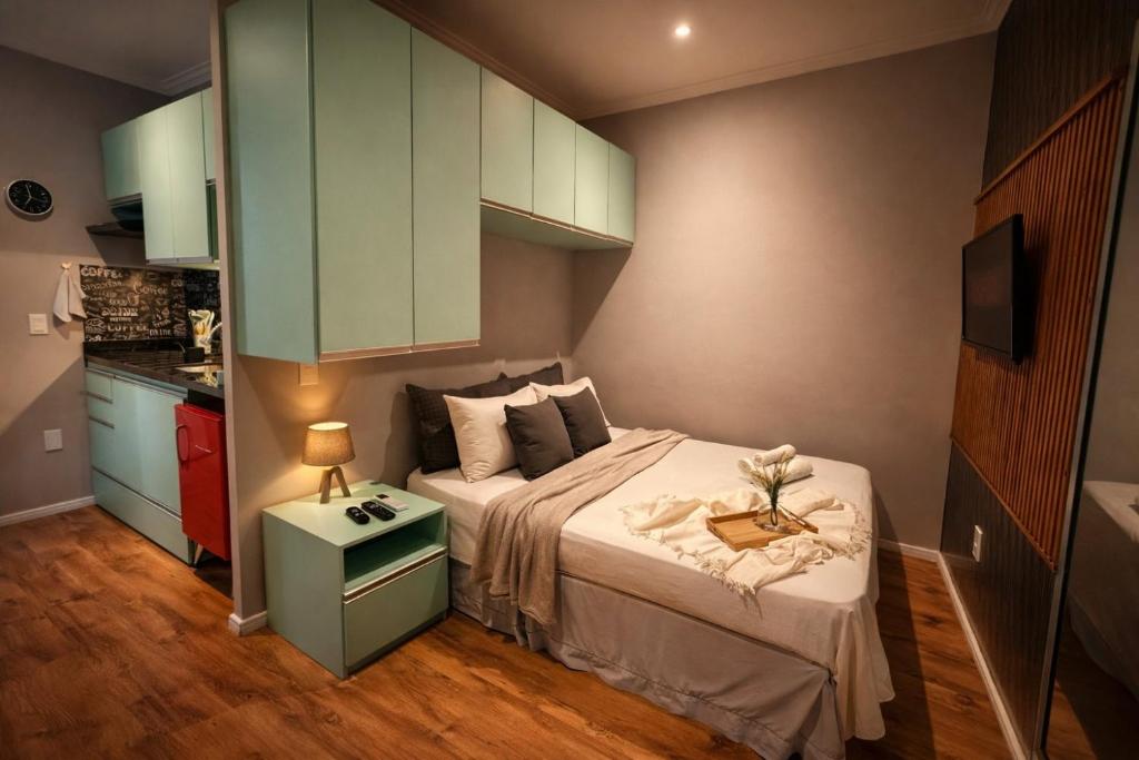 a small bedroom with a bed and a tv at The Birthplace of Samba Carioca in Rio de Janeiro