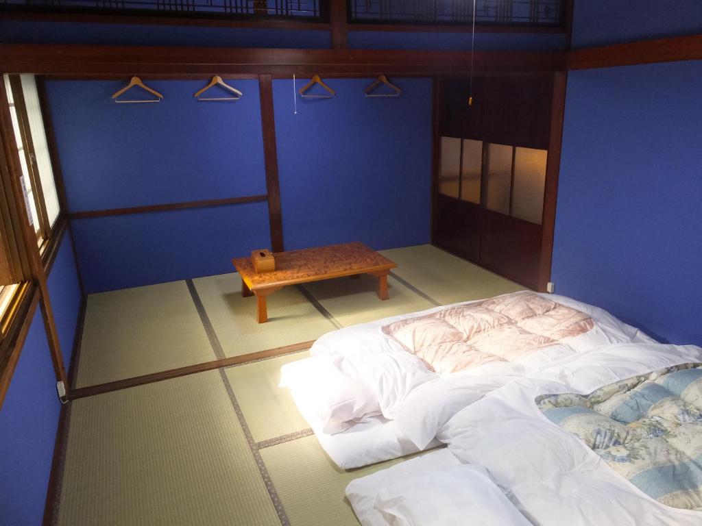 Postel nebo postele na pokoji v ubytování Guesthouse Mikkaichi