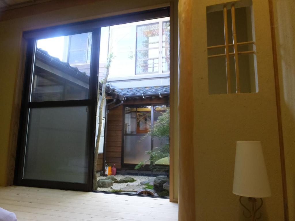 Postel nebo postele na pokoji v ubytování Guesthouse Mikkaichi