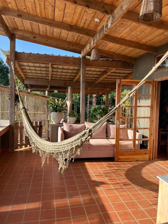 a hammock on a patio under a pergola at Jua Zuri in Lushoto