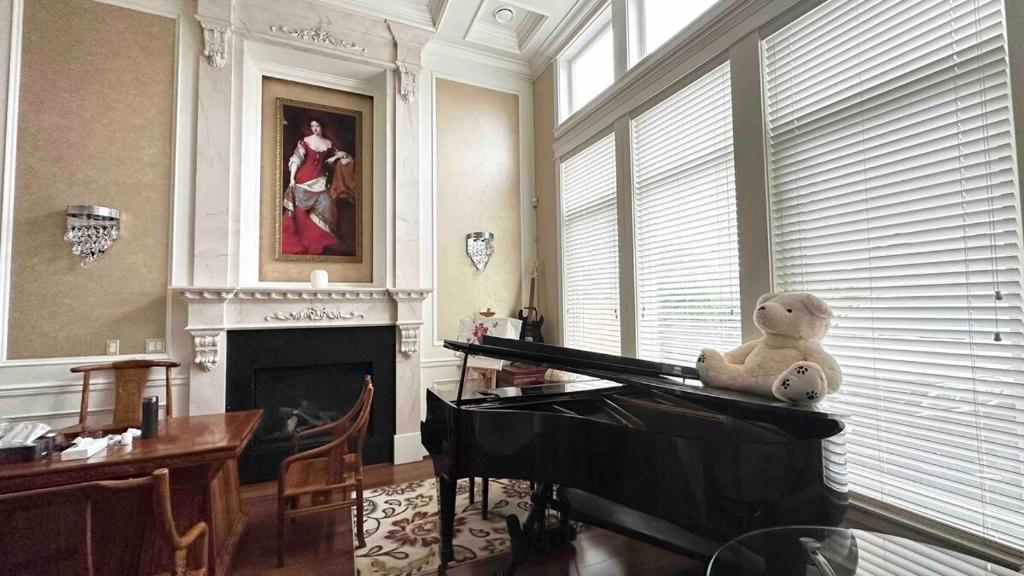 a stuffed teddy bear sitting on top of a piano at Luxury Private house in Richmond