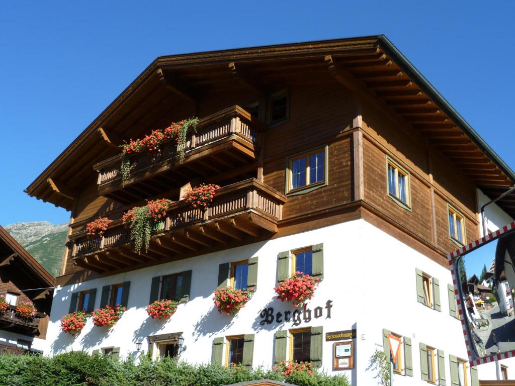 a building with balconies and flowers on it at Berghof in Berwang