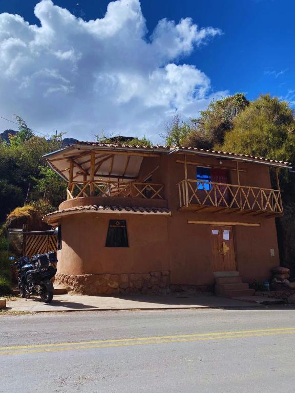 a building with a motorcycle parked in front of it at Apu House in Calca