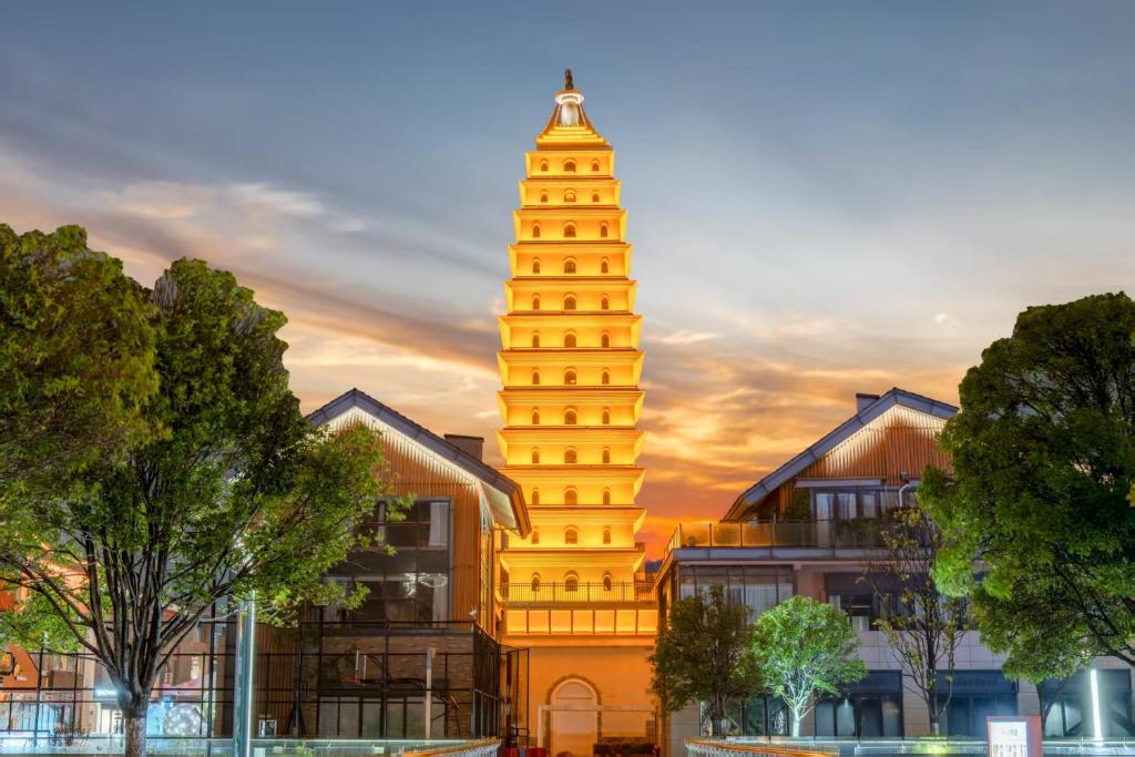 a tall building with a clock tower in the background at Phoenix Dragon M.I.C.E Hotel in Kunming