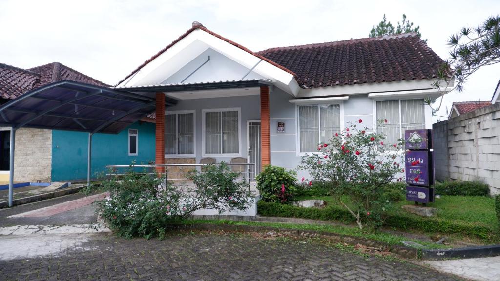 a small house with a blue and white at Diyar Villas Puncak F4/8 in Puncak
