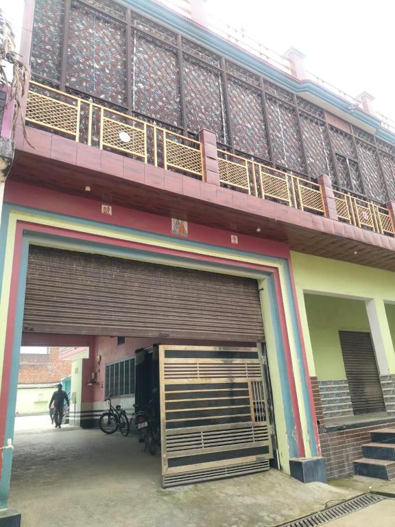 a building with a large garage door with a balcony at Shobhit homestay in Amroha