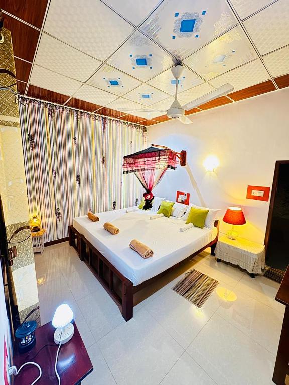a large bedroom with a large bed and a couch at Freedom Cottage & Safari in Tissamaharama