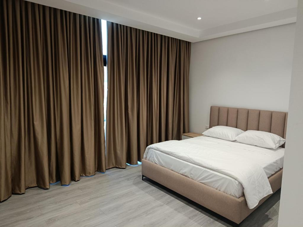 a bedroom with a bed and a large window at Rezidenca Pahumi 2 in Durrës