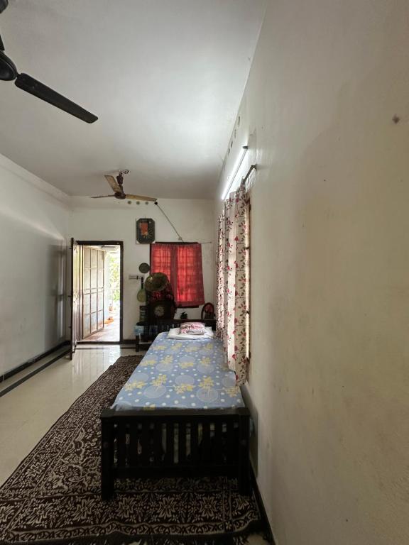 a living room with a couch in the middle of a room at Hostel Honsa in Cochin