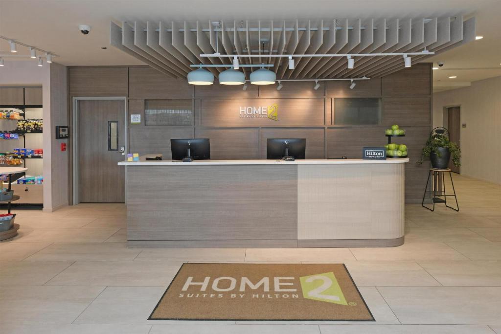a home store lobby with a welcome sign on the floor at Home2 Suites By Hilton Lima in Lima