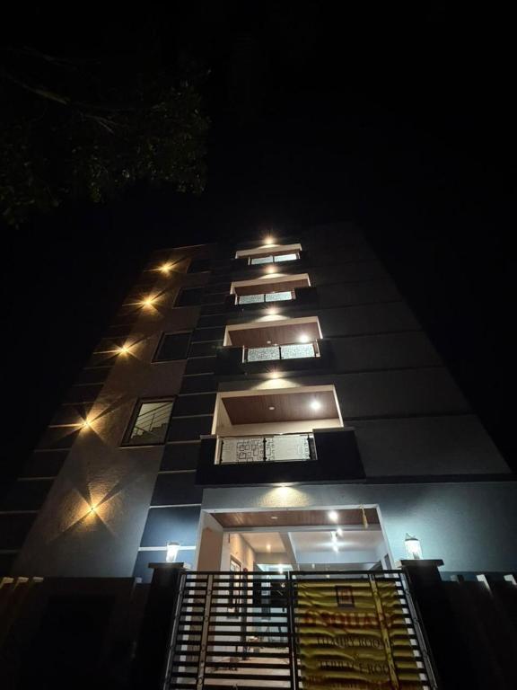 a tall building with lights on it at night at G square The Premium Hotel in Rushikonda