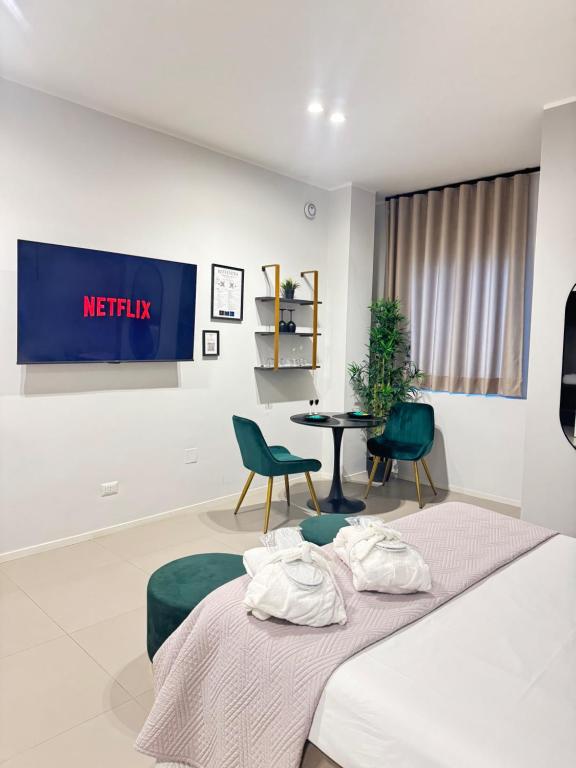 a hotel room with a bed and a table and chairs at Luxury apartment - SUITE CAVOUR in Bari