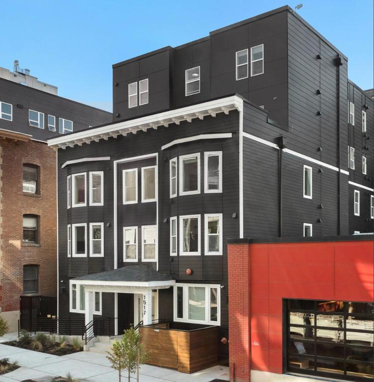 a black apartment building with a red facade at The Boylston Hotel Capitol Hill in Seattle