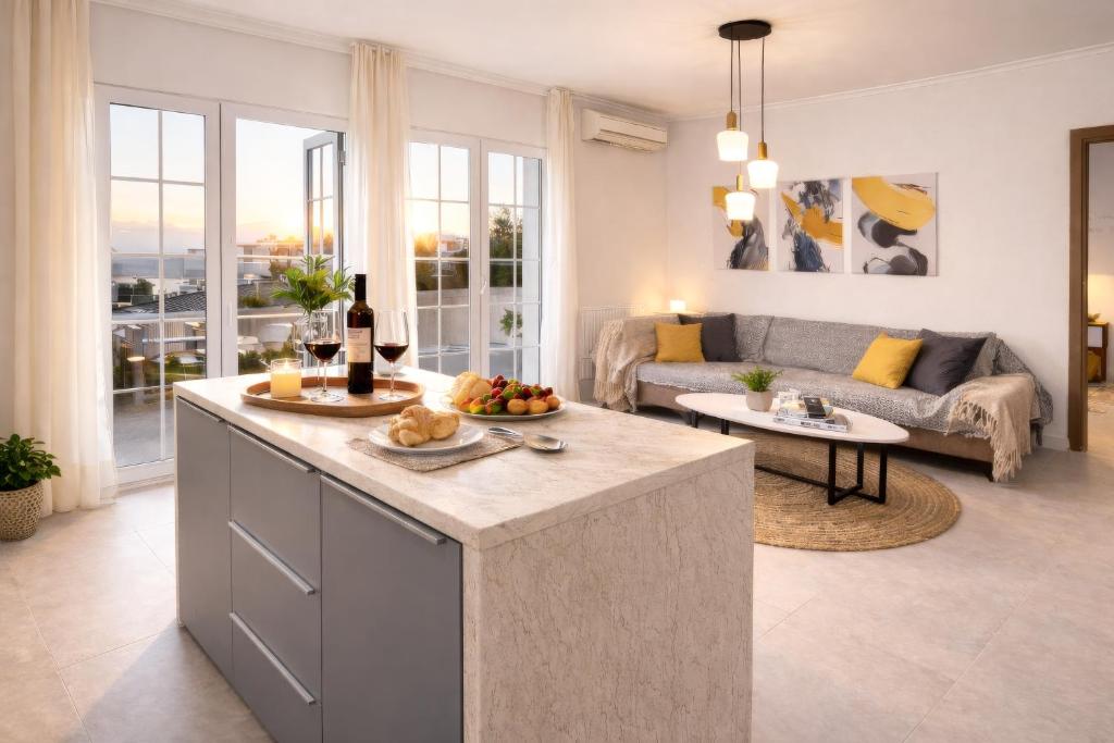 a kitchen and living room with a couch at A Comfortable Stay with Balcony and Easy Parking near Kalamata Center in Kalamata