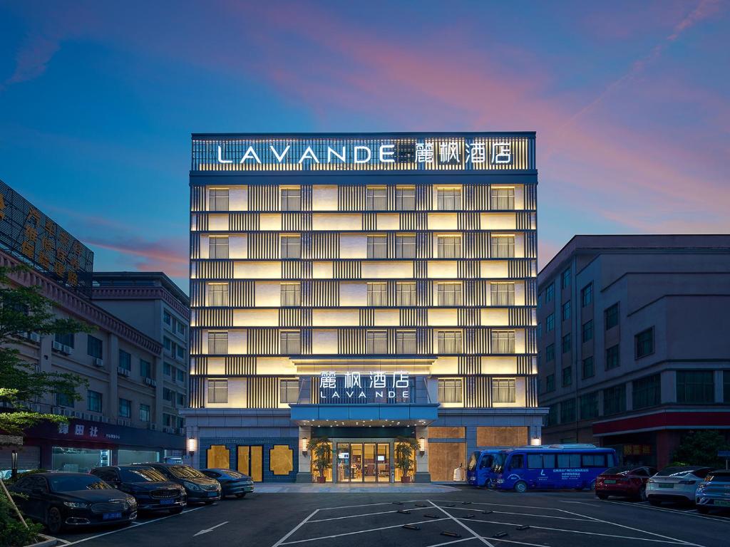 a large building with a sign on the top of it at Lavande International Hotel Guangzhou Baiyun International Airport Renhe Metro Station Branch - Free Shuttle Bus to Guangzhou Baiyun International Airport in Guangzhou