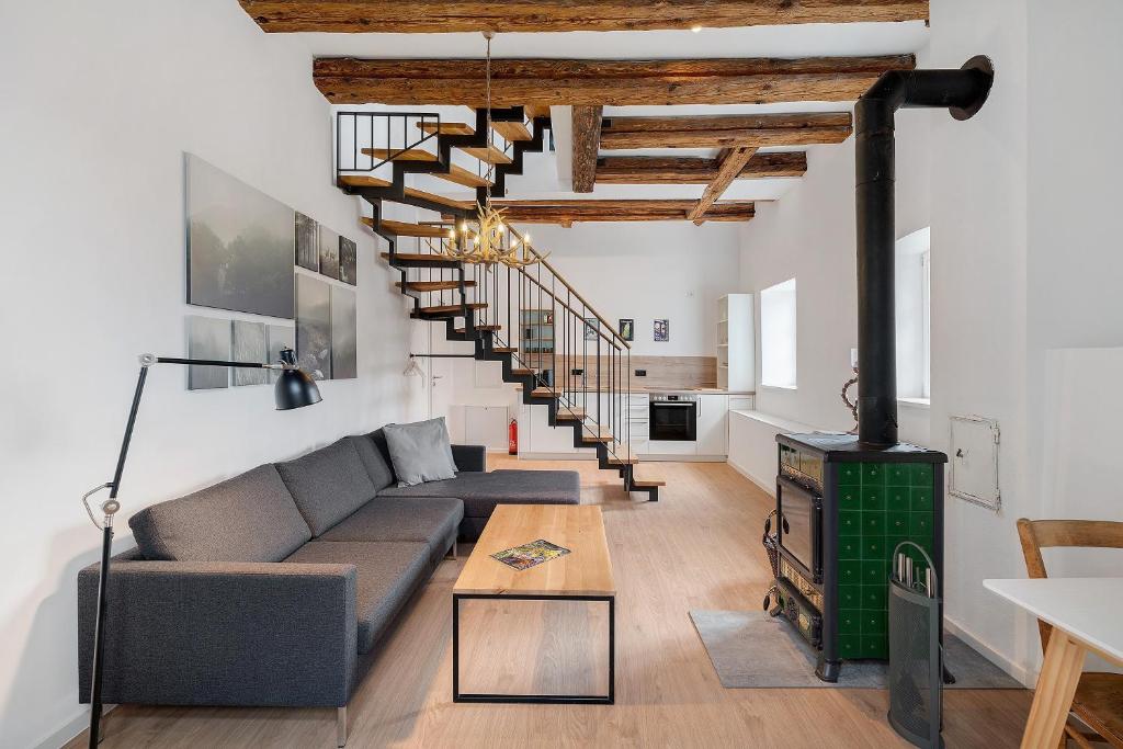 a living room with a couch and a wood stove at Altes Forstamt in Gernsbach