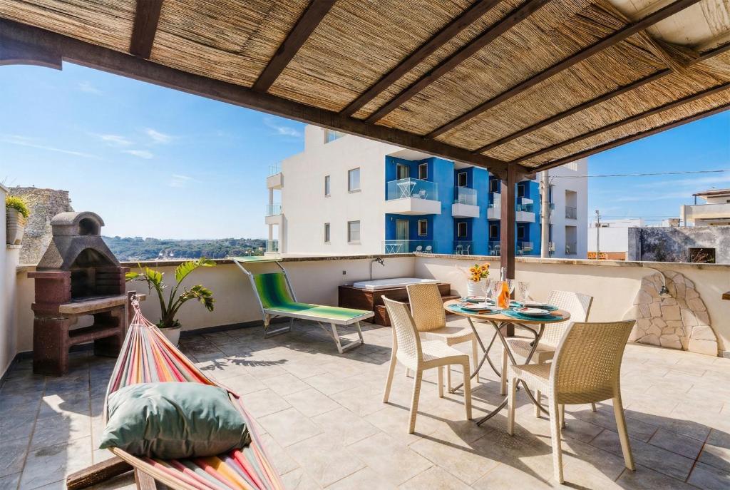 a patio with a table and chairs on a roof at Casa Azzurra a Torre dell'Orso in Torre dell'Orso
