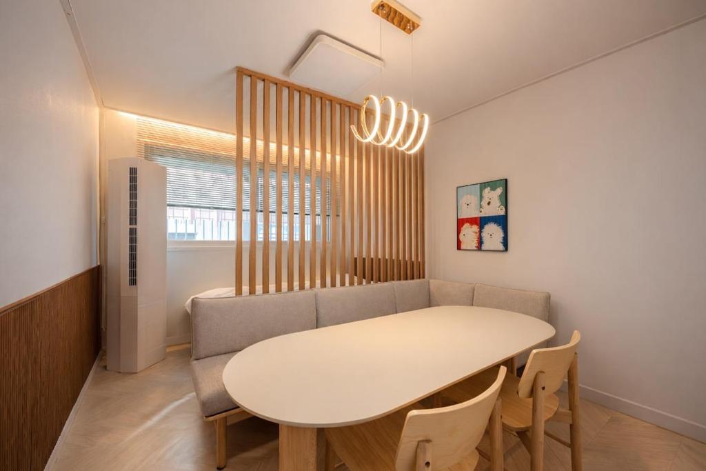 a dining room with a table and a couch at Eunpyeong St Mary's Hospital Yeonsinnae Station 3R3B Bukhansan 인사동 Namsan DDP 동대문 명동 Itaewon 20 mins in Seoul