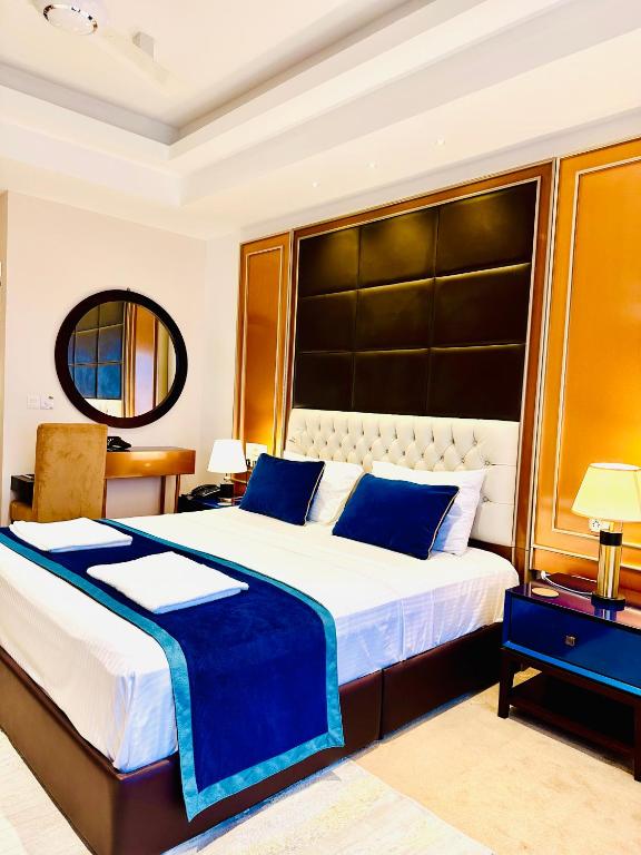 a bedroom with a large bed with a large headboard at Sea view Serenity Negombo in Negombo