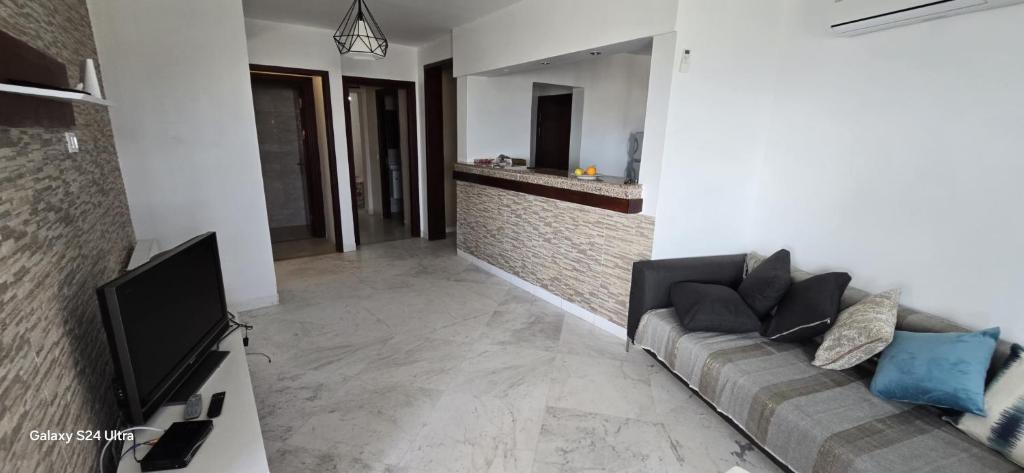 a living room with a couch and a tv at Bizerte appartement in Bizerte