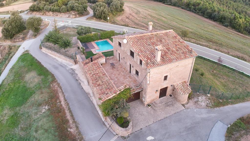 an aerial view of a house with a swimming pool at Cal Fortic, Navès in Navés