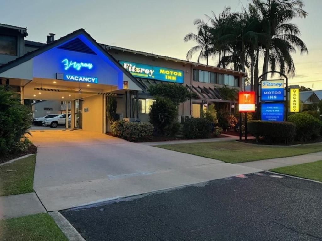 a grocery store with a sign in front of it at Fitzroy Motor Inn in Grafton