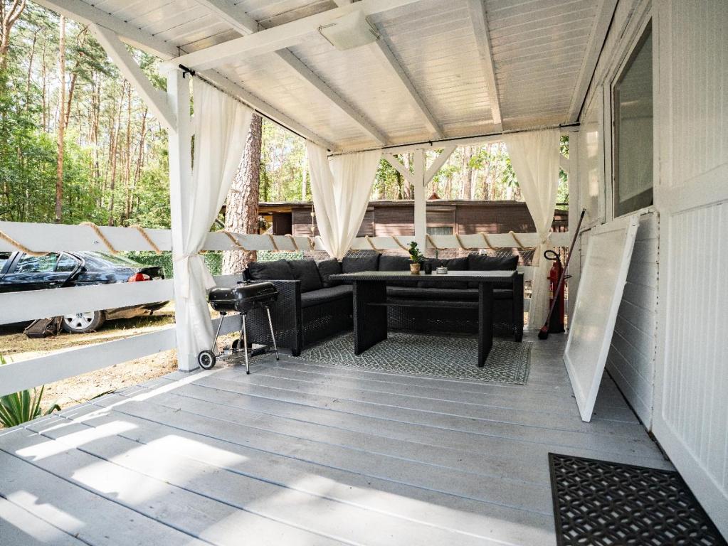 a screened in porch with a table and chairs at Laguna Turawa in Turawa