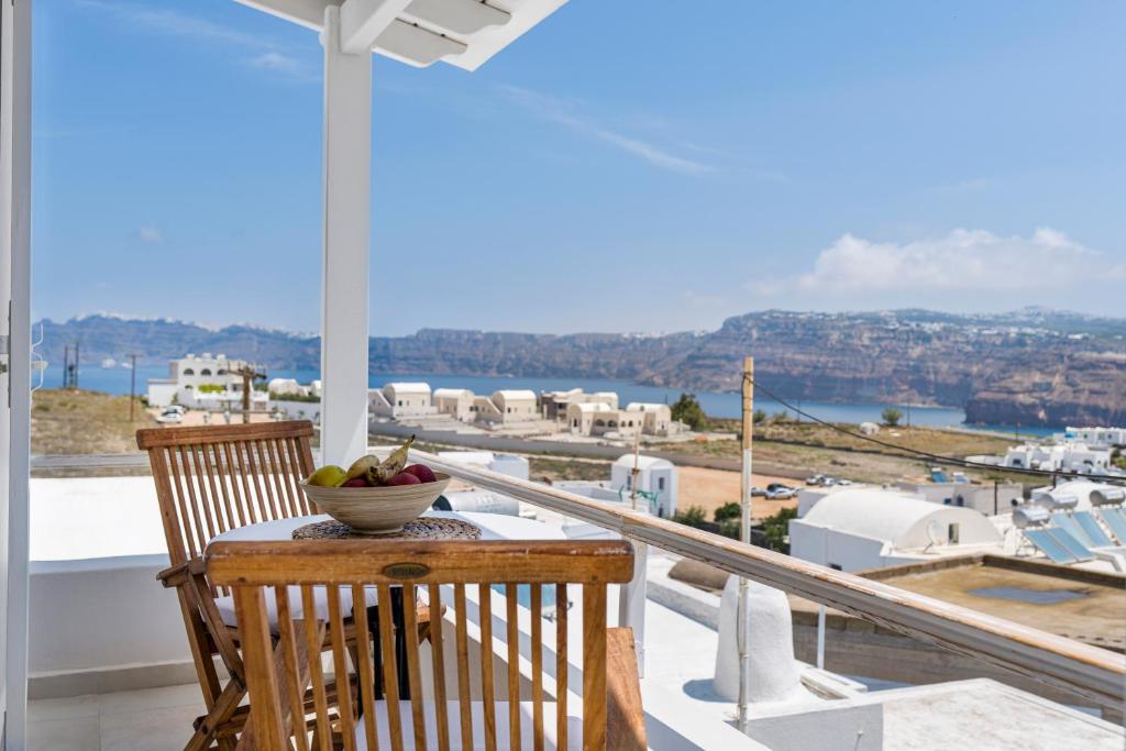 a bowl of fruit sitting on a table on a balcony at Casa View in Akrotiri