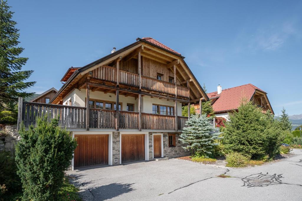 an exterior view of a large house with a balcony at Alpen Chalet Forest in Mauterndorf