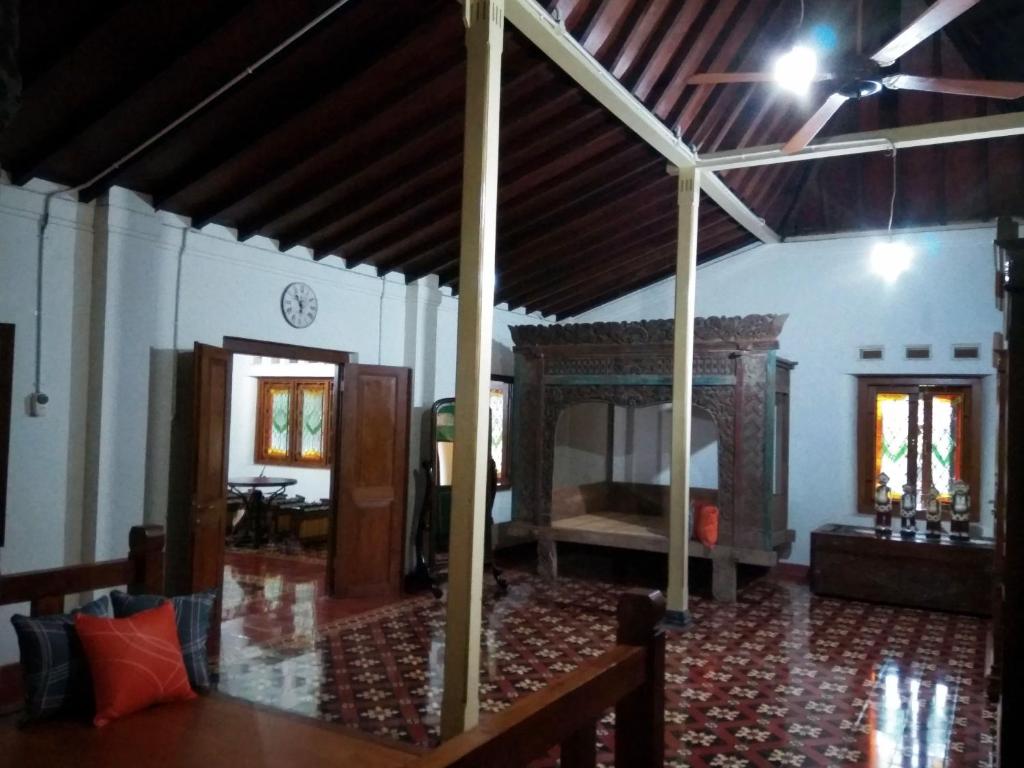 a living room with a room with a bed in it at Omah Pitoe Yogya Homestay in Yogyakarta