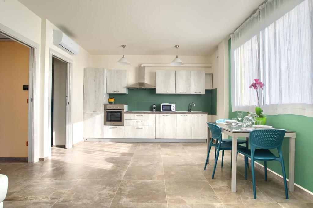 a kitchen with a table and chairs in a room at Iris - Costadoro Holiday Home in Imperia