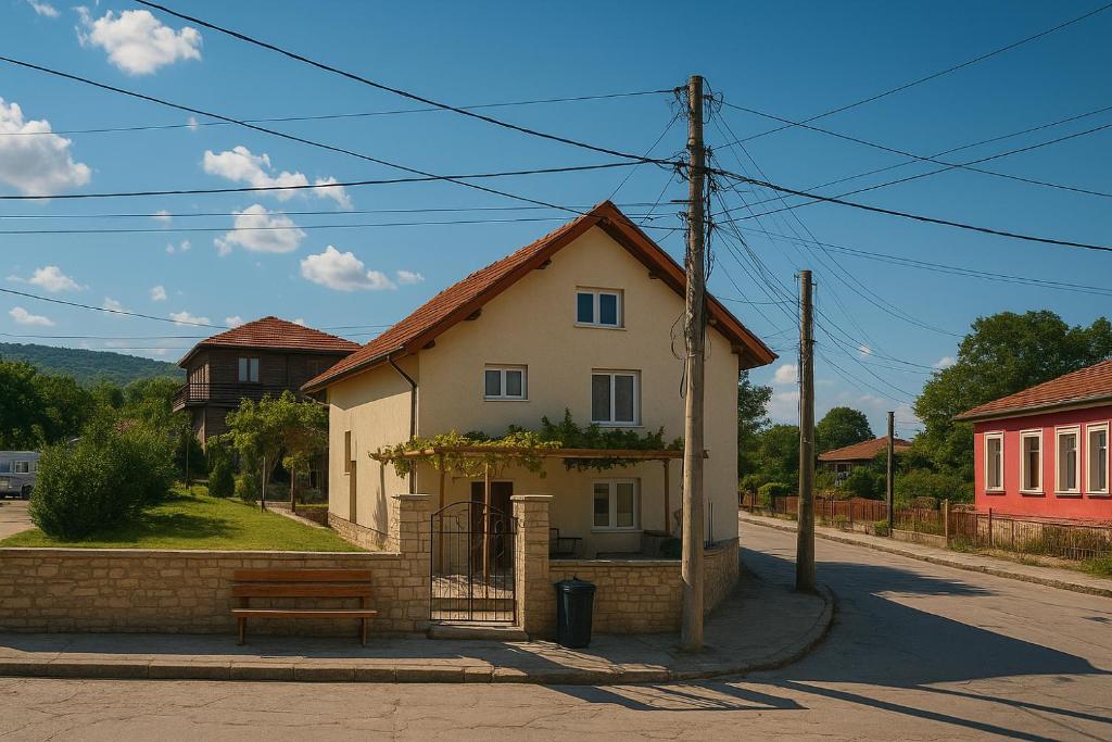 a small white house on the side of a street at Стаи за гости - Дара Девня 1 in Devnya