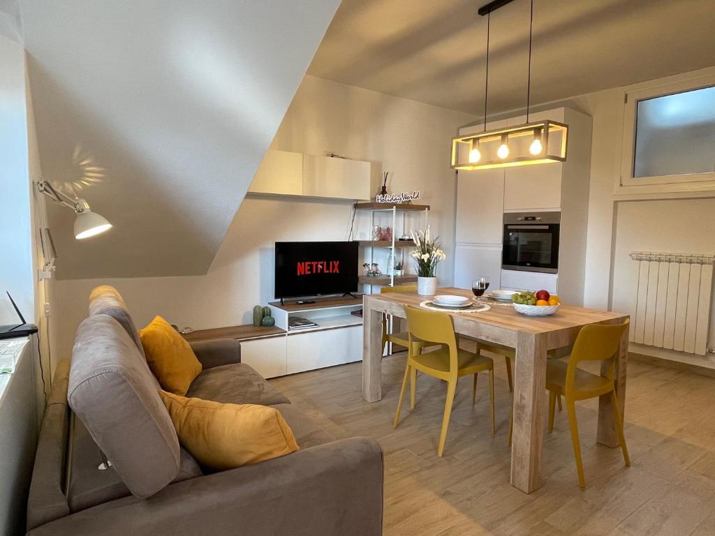 a kitchen and living room with a table and a couch at Casa Marì by Holiday World in Sulzano