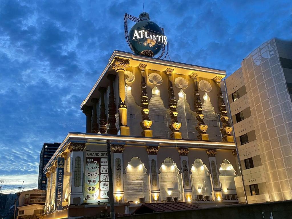 a building with a sign on the top of it at HOTEL ATLANTIS IKUTAMA -Adult Only in Osaka